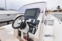 2019 Capelli Tempest 1000 Open boat dashboard with steering wheel and navigation system.