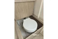 Compact marine toilet in 2019 Capelli Tempest 1000 Open boat, featuring wooden cabinetry.