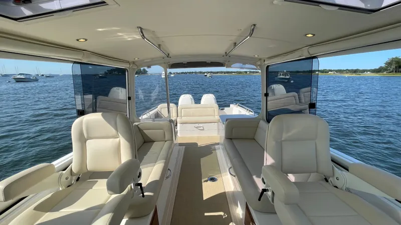 Corsair Yacht Photos Pics Interior view of 2020 MJM 35z boat with luxurious seating and scenic water backdrop.