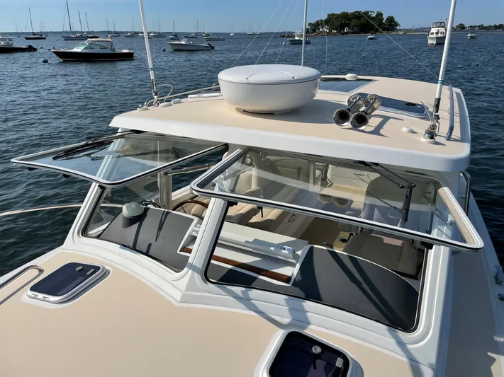 Corsair Yacht Photos Pics 2020 MJM 35z boat on water with open windows and visible seating area.