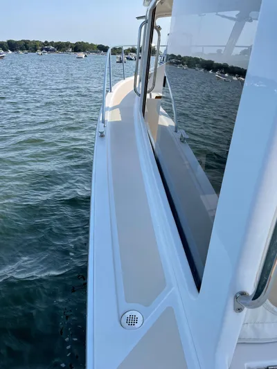 Corsair Yacht Photos Pics 2020 MJM 35z boat on water, side view with clear skies and distant shoreline.