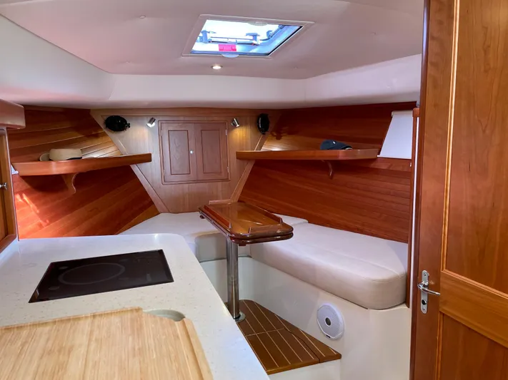Corsair Yacht Photos Pics Interior of 2020 MJM 35z boat with wood paneling and seating area.