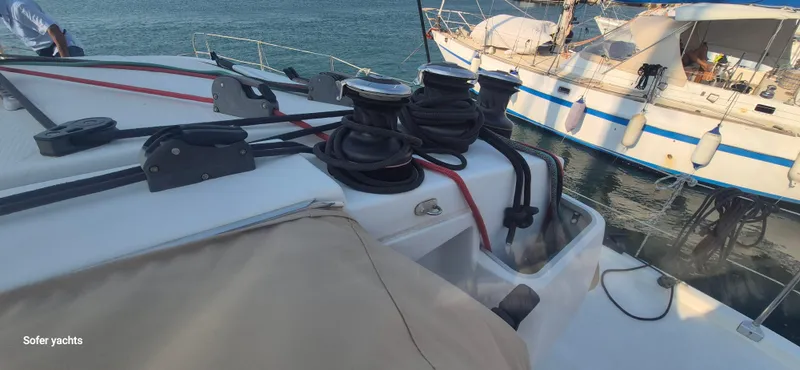  Yacht Photos Pics Fountaine Pajot Lipari 41 catamaran deck with ropes and winches, docked beside another boat.