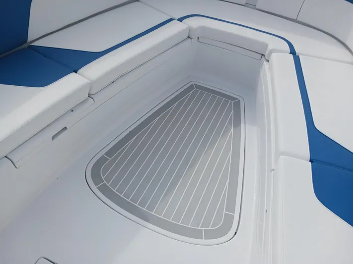  Yacht Photos Pics 2024 Intrepid 375 Nomad SE boat seating area with blue and white cushions.