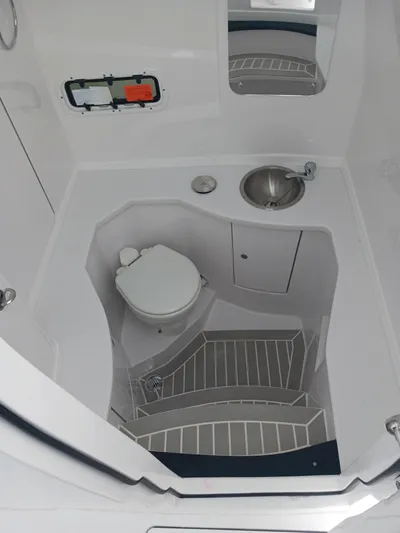  Yacht Photos Pics 2024 Intrepid 375 Nomad SE boat bathroom with toilet, sink, and modern design.
