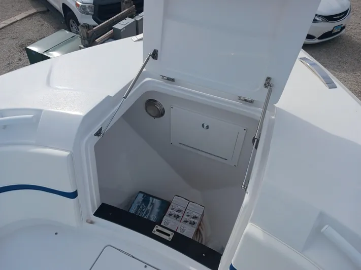  Yacht Photos Pics 2024 Intrepid 375 Nomad SE boat storage compartment with open hatch, showing interior space.