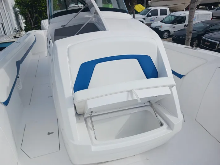  Yacht Photos Pics 2024 Intrepid 375 Nomad SE boat with open storage compartment on deck.