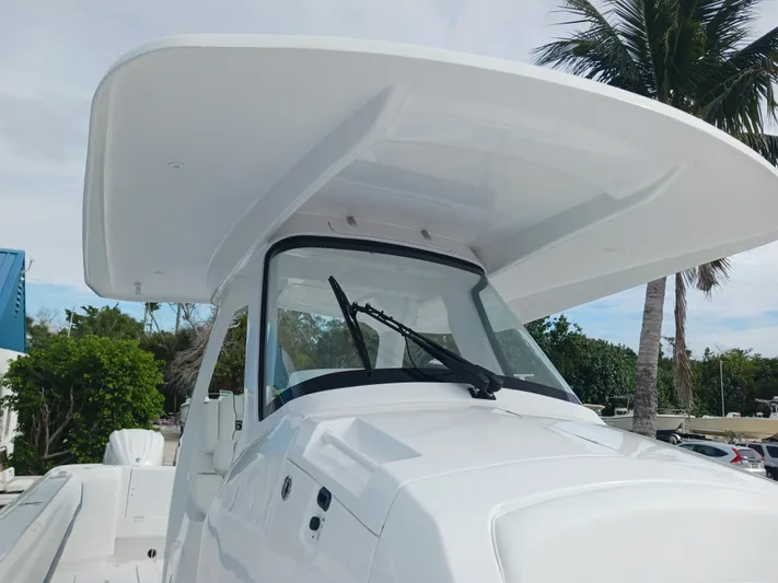  Yacht Photos Pics 2024 Intrepid 375 Nomad SE boat with sleek design and spacious cockpit under a clear sky.