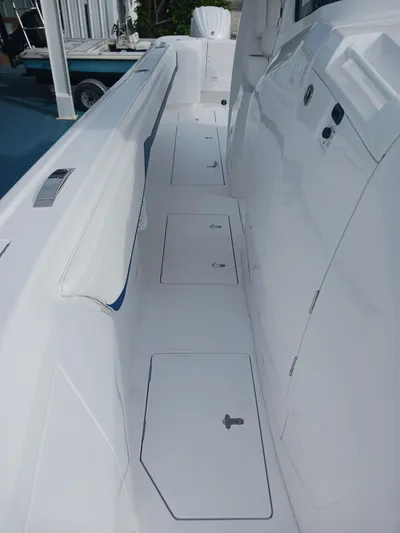  Yacht Photos Pics 2024 Intrepid 375 Nomad SE boat deck with storage compartments and sleek design.