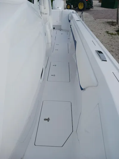  Yacht Photos Pics 2024 Intrepid 375 Nomad SE boat deck with storage compartments.