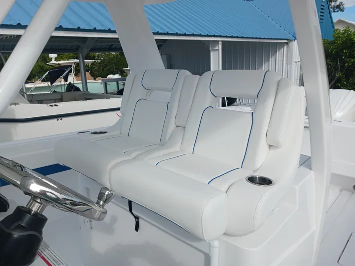  Yacht Photos Pics 2024 Intrepid 375 Nomad SE boat seats with white upholstery and blue accents.
