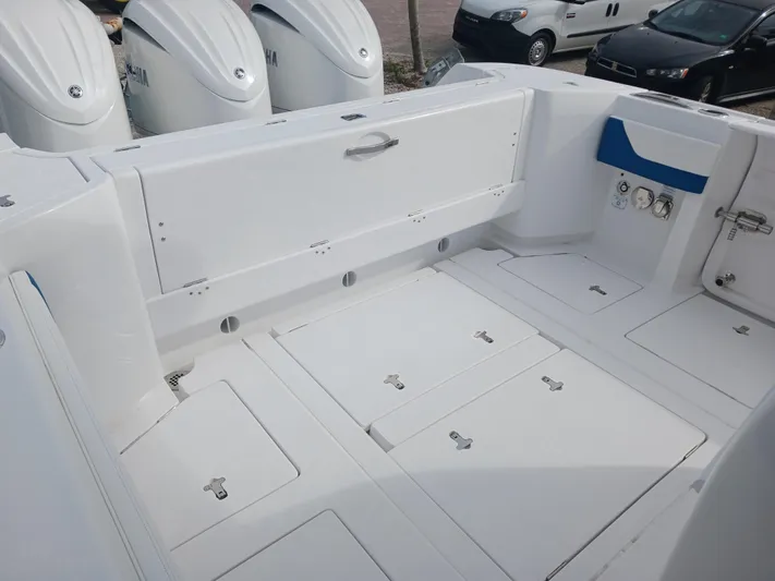  Yacht Photos Pics 2024 Intrepid 375 Nomad SE boat deck with storage compartments and Yamaha engines.