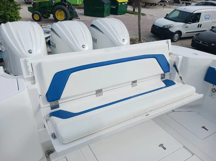  Yacht Photos Pics 2024 Intrepid 375 Nomad SE boat with foldable white and blue seating.