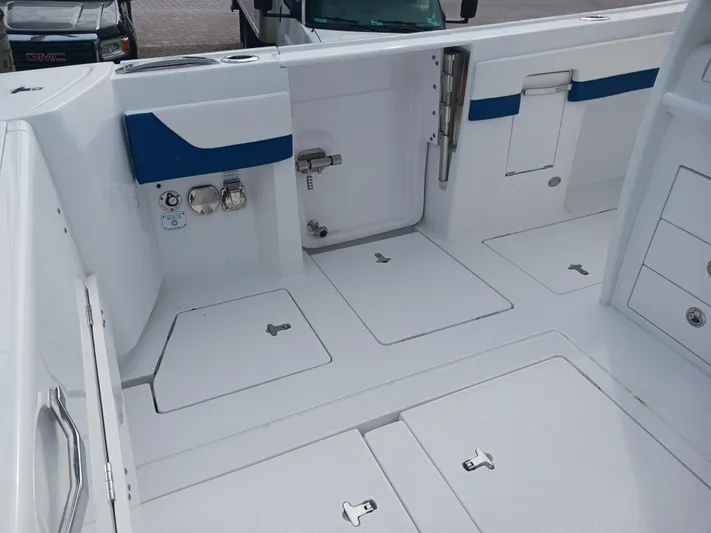  Yacht Photos Pics 2024 Intrepid 375 Nomad SE boat deck with storage compartments and sleek design.