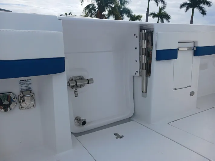  Yacht Photos Pics 2024 Intrepid 375 Nomad SE boat interior with open hatch and blue accents.