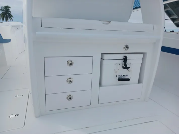  Yacht Photos Pics 2024 Intrepid 375 Nomad SE boat interior with storage drawers and cooler.