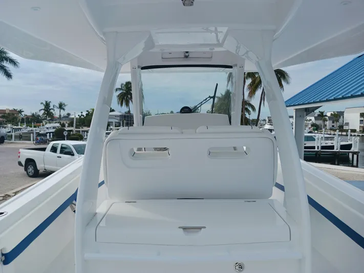  Yacht Photos Pics 2024 Intrepid 375 Nomad SE boat interior with seating, docked at marina.