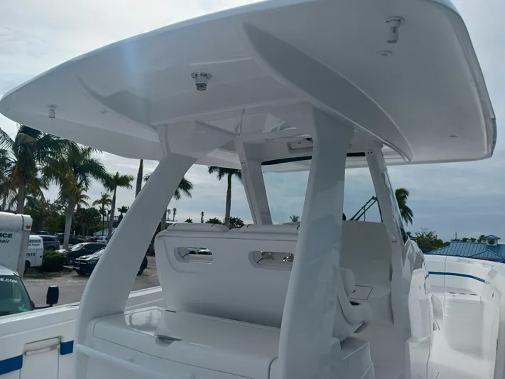  Yacht Photos Pics 2024 Intrepid 375 Nomad SE boat with sleek design and spacious seating, set against a tropical backdrop.