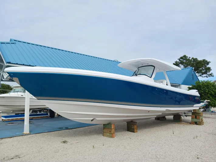  Yacht Photos Pics 2024 Intrepid 375 Nomad SE boat with sleek blue and white design on display.