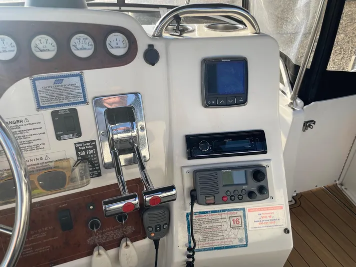  Yacht Photos Pics 1999 Silverton 392 Motor Yacht helm with gauges, controls, and navigation equipment.