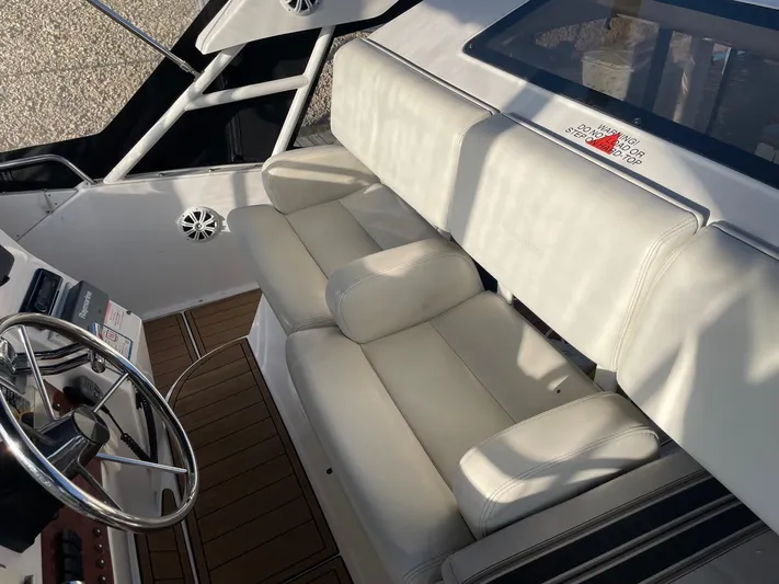  Yacht Photos Pics 1999 Silverton 392 Motor Yacht interior with white seating and steering wheel.