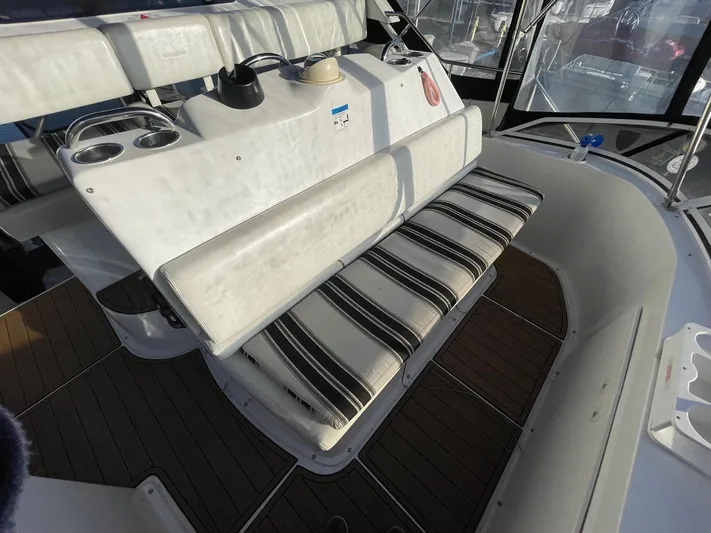  Yacht Photos Pics 1999 Silverton 392 Motor Yacht interior with striped seating and wooden flooring.