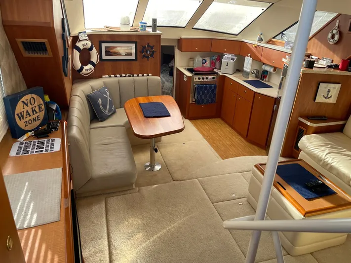  Yacht Photos Pics Interior of 1999 Silverton 392 Motor Yacht with cozy seating and kitchen area.