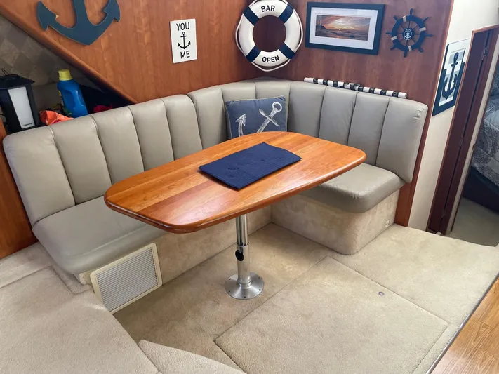  Yacht Photos Pics 1999 Silverton 392 Motor Yacht interior with cozy dining area and nautical decor.