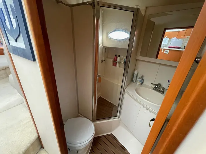  Yacht Photos Pics 1999 Silverton 392 Motor Yacht bathroom with shower, sink, and toilet.