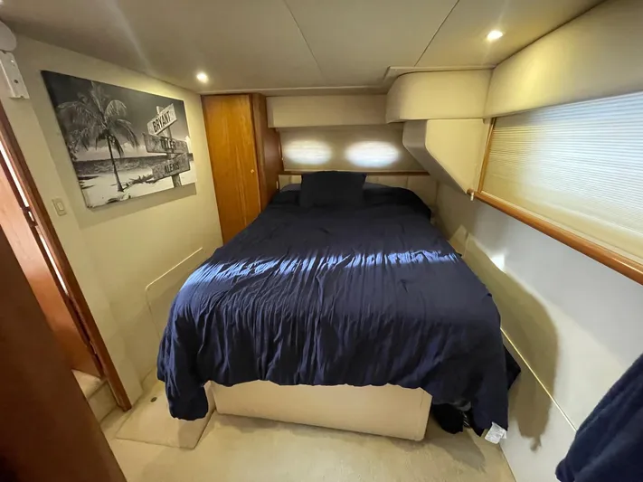 Yacht Photos Pics Cozy bedroom in 1999 Silverton 392 Motor Yacht with navy bedding and wall art.