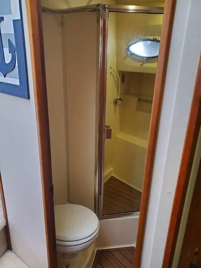  Yacht Photos Pics 1999 Silverton 392 Motor Yacht bathroom with shower and porthole window.