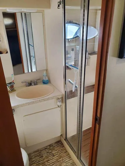  Yacht Photos Pics 1999 Silverton 392 Motor Yacht bathroom with shower, sink, and mirror.