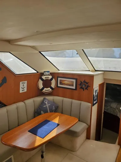  Yacht Photos Pics 1999 Silverton 392 Motor Yacht interior with skylights, dining area, and nautical decor.