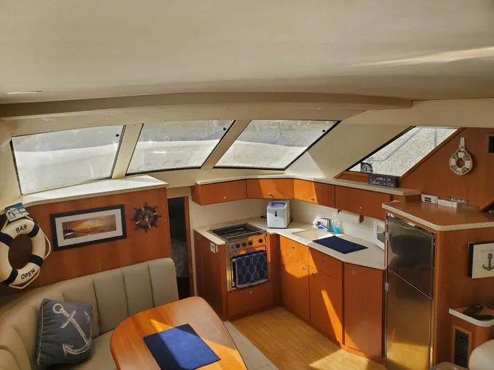  Yacht Photos Pics Interior of a 1999 Silverton 392 Motor Yacht with kitchen and seating area.