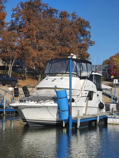  Yacht Photos Pics 1999 Silverton 392 Motor Yacht docked at a marina in autumn.