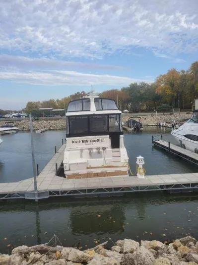  Yacht Photos Pics 1999 Silverton 392 Motor Yacht docked at a marina with autumn trees in the background.
