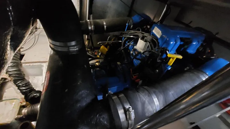  Yacht Photos Pics Engine room of a 1999 Silverton 392 Motor Yacht with visible blue engine components.