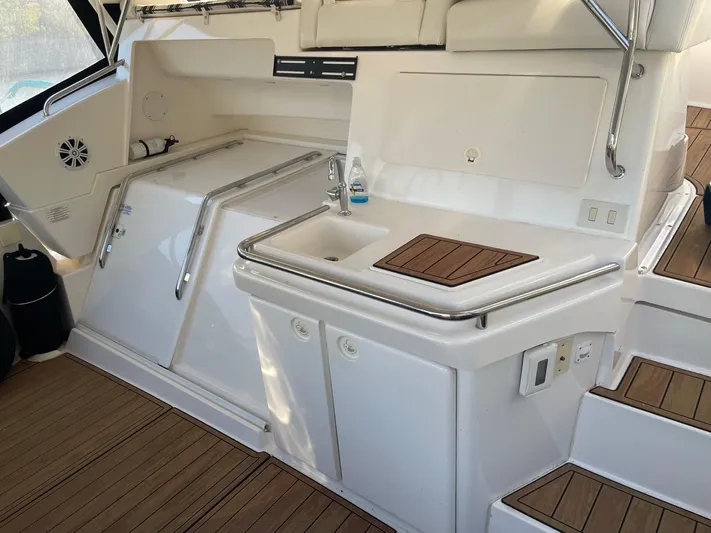  Yacht Photos Pics 1999 Silverton 392 Motor Yacht interior with sink, storage, and wooden flooring.
