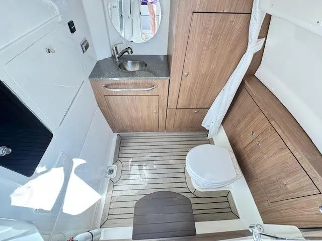  Yacht Photos Pics 2016 Boston Whaler 350 Outrage boat bathroom with wood accents and modern fixtures.