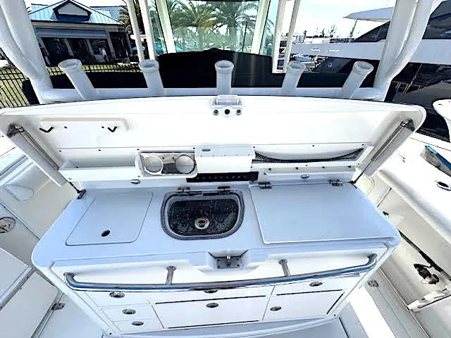  Yacht Photos Pics 2016 Boston Whaler 350 Outrage boat interior with sink and storage compartments.