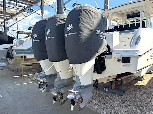  Yacht Photos Pics 2016 Boston Whaler 350 Outrage with triple Mercury engines, docked and covered.