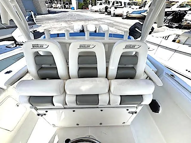  Yacht Photos Pics 2016 Boston Whaler 350 Outrage boat interior with white cushioned seating.
