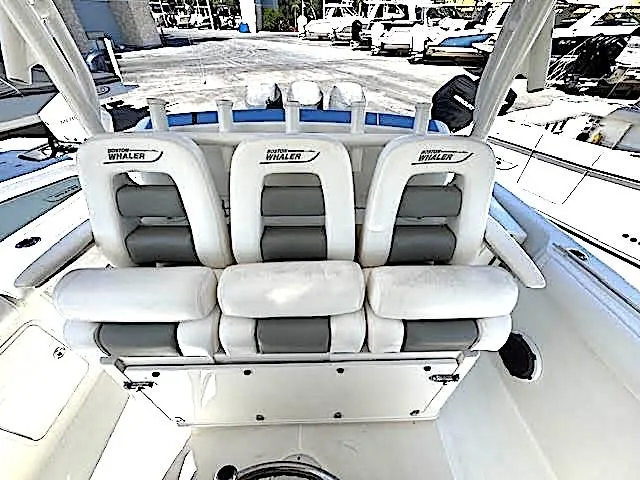 Yacht Photos Pics 2016 Boston Whaler 350 Outrage boat seating, white and gray upholstery, docked at marina.