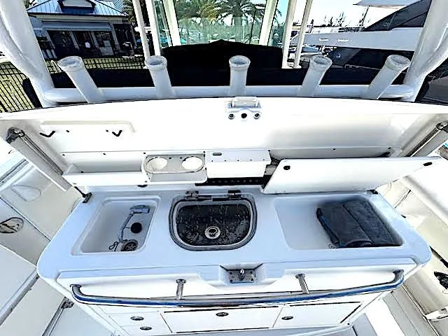  Yacht Photos Pics 2016 Boston Whaler 350 Outrage boat interior with fishing station and storage compartments.
