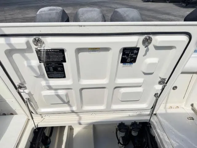  Yacht Photos Pics 2016 Boston Whaler 350 Outrage engine compartment with open hatch, showing mechanical components.