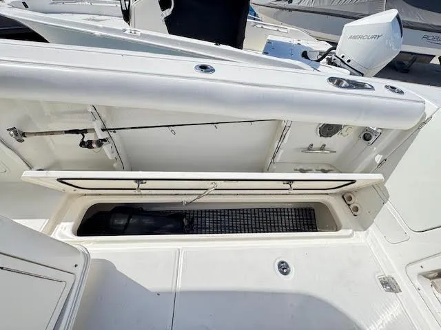  Yacht Photos Pics 2016 Boston Whaler 350 Outrage boat storage compartment open, showcasing interior space.