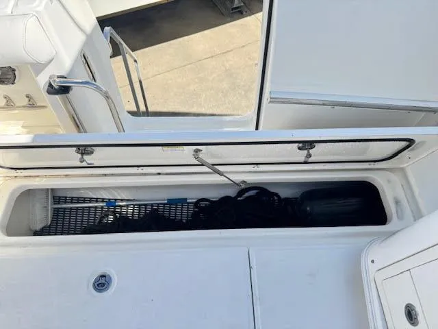  Yacht Photos Pics 2016 Boston Whaler 350 Outrage storage compartment with open lid, showcasing interior space.