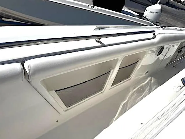  Yacht Photos Pics 2016 Boston Whaler 350 Outrage boat interior with storage compartments and sleek design.