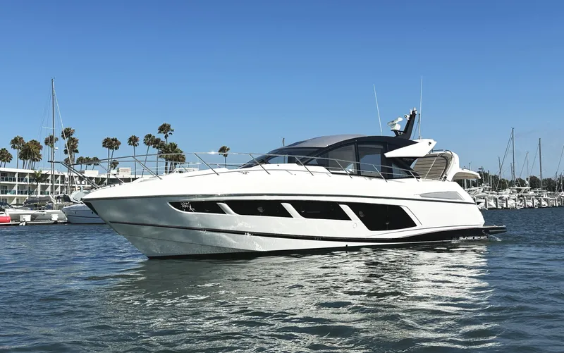 Forever Young Yacht Photos Pics 2019 Sunseeker Predator 57 yacht on water, clear sky, marina background.