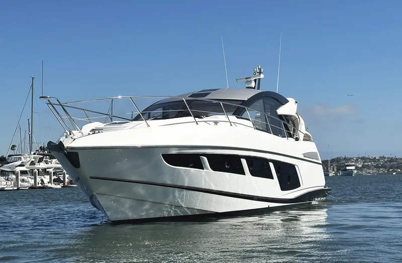 Forever Young Yacht Photos Pics 2019 Sunseeker Predator 57 yacht on water, showcasing sleek design and luxury features.